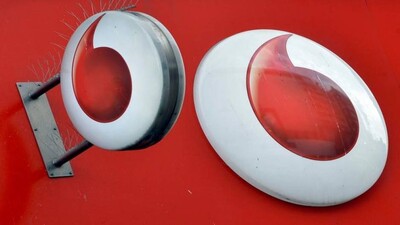 Vodafone branding is seen outside a retail store in London