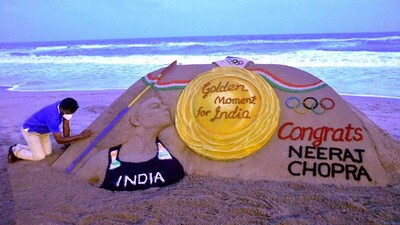 Sand Artist Sudarshan Pattnaik creates a sculpture for Javelin thrower Neeraj Chopra in Puri Beach