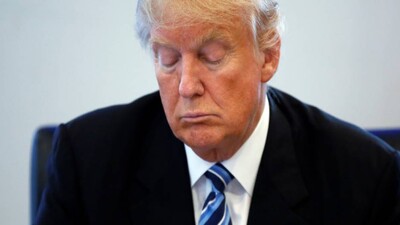 Republican presidential nominee Donald Trump reads a document during a round table discussion on security at Trump Tower in the Manhattan borough of New York