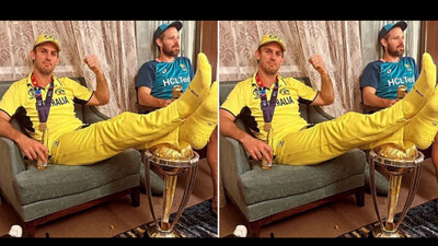 Mitchell Marsh keeps his feet on the World Cup Trophy